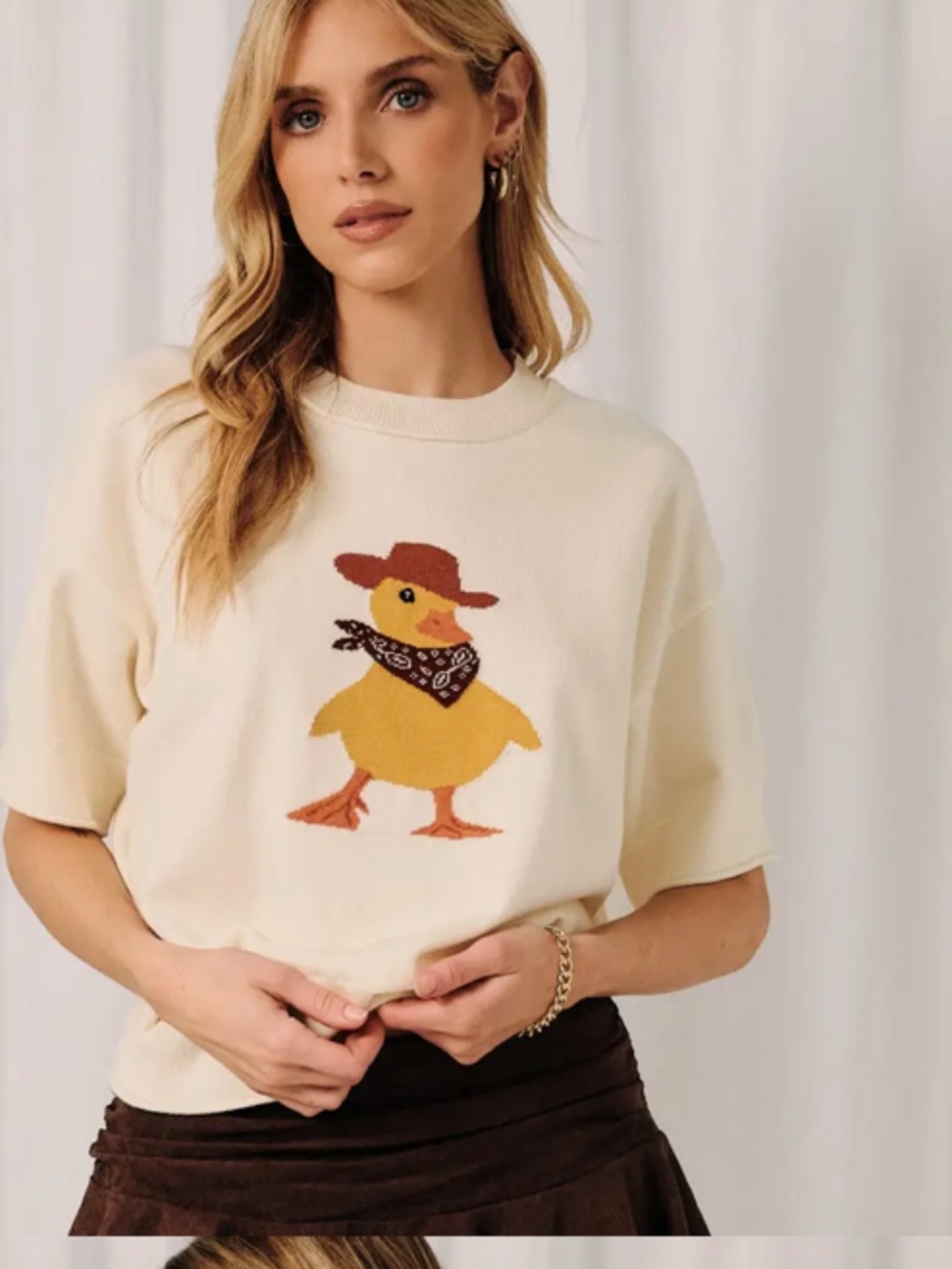 Sunday Edition short sleeve duck sweater with cowboy hat on.